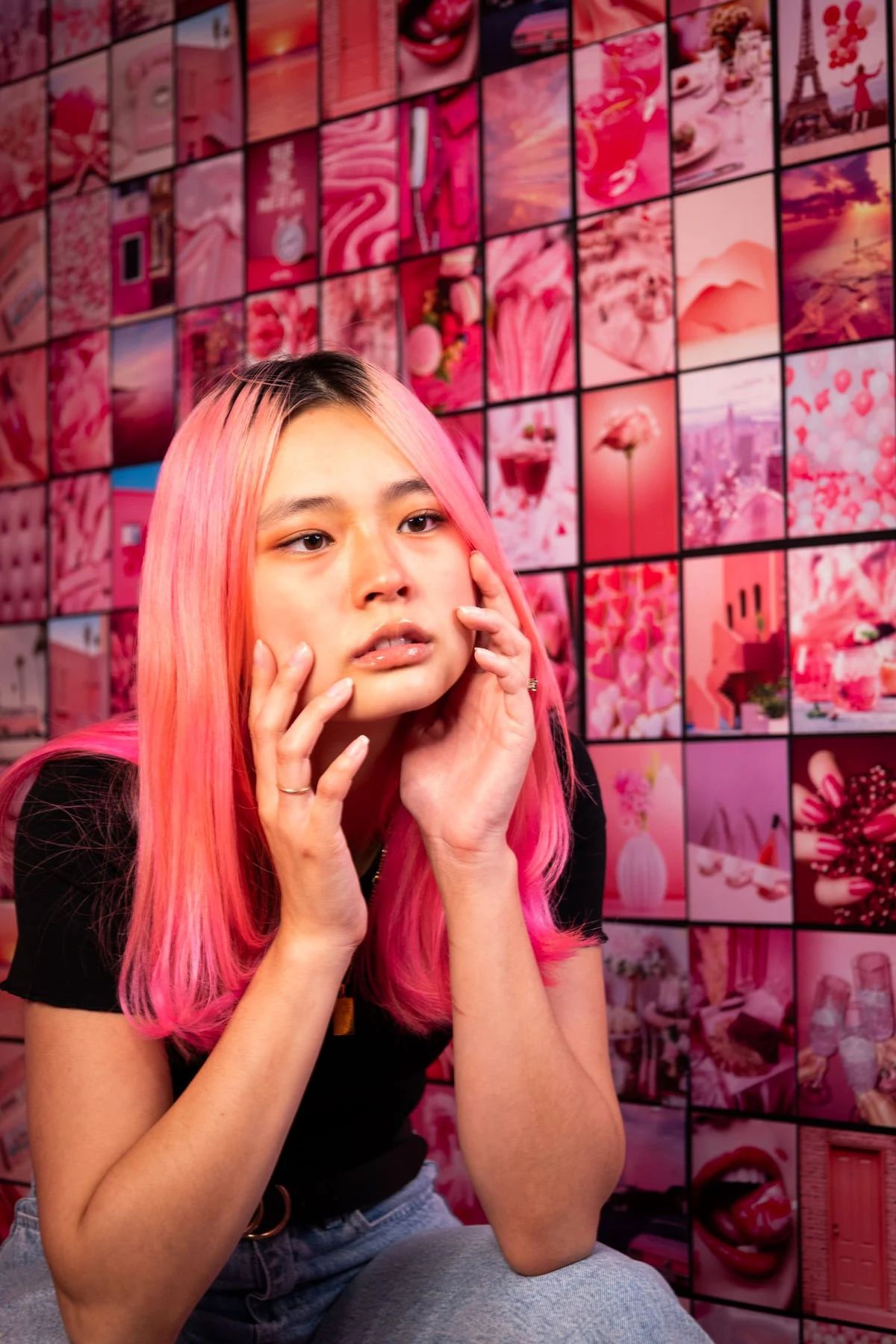 Pink hair against a wall of pink photos